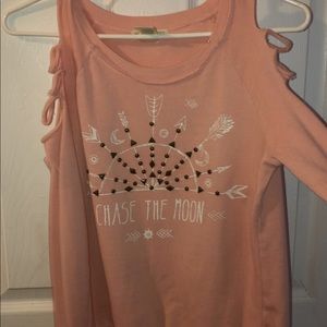 Pink sweater ripped at the shoulders